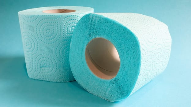 Blue roll of modern toilet paper on a blue background. A paper product on a cardboard sleeve, used for sanitary purposes from cellulose with cutouts for easy tearing. Embossed drawing.