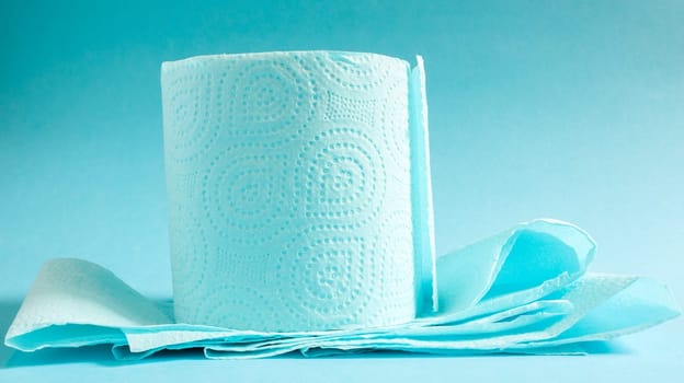 Blue roll of modern toilet paper on a blue background. A paper product on a cardboard sleeve, used for sanitary purposes from cellulose with cutouts for easy tearing. Embossed drawing.