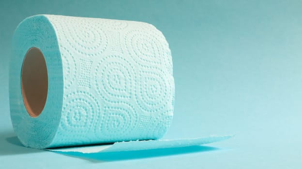 Blue roll of modern toilet paper on a blue background. A paper product on a cardboard sleeve, used for sanitary purposes from cellulose with cutouts for easy tearing. Embossed drawing. copy space