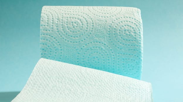 Blue roll of modern toilet paper on a blue background. A paper product on a cardboard sleeve, used for sanitary purposes from cellulose with cutouts for easy tearing. Embossed drawing.