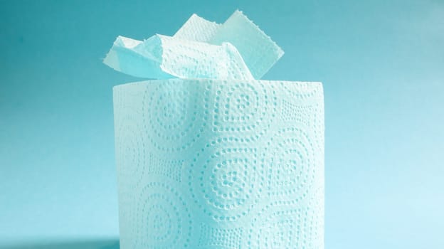 Blue roll of modern toilet paper on a blue background. A paper product on a cardboard sleeve, used for sanitary purposes from cellulose with cutouts for easy tearing. Embossed drawing.