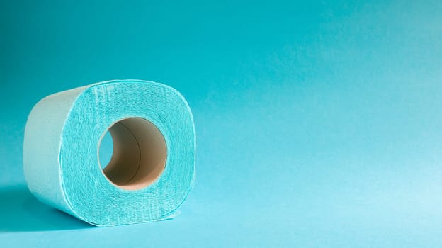 Blue roll of modern toilet paper on a blue background. A paper product on a cardboard sleeve, used for sanitary purposes from cellulose with cutouts for easy tearing. Embossed drawing. copy space