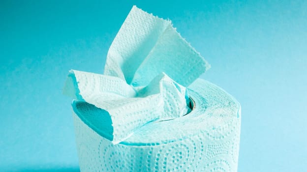 Blue roll of modern toilet paper on a blue background. A paper product on a cardboard sleeve, used for sanitary purposes from cellulose with cutouts for easy tearing. Embossed drawing.
