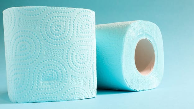 Blue roll of modern toilet paper on a blue background. A paper product on a cardboard sleeve, used for sanitary purposes from cellulose with cutouts for easy tearing. Embossed drawing.