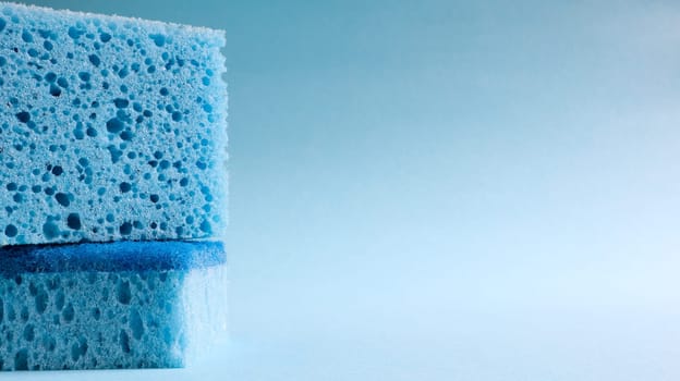 Two blue sponges used for washing and erasing dirt used by housewives in everyday life. They are made of porous material such as foam. Detergent retention, which allows you to spend it economically.