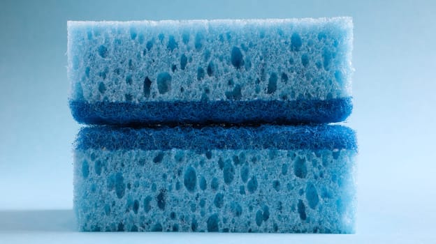 Two blue sponges used for washing and erasing dirt used by housewives in everyday life. They are made of porous material such as foam. Detergent retention, which allows you to spend it economically.