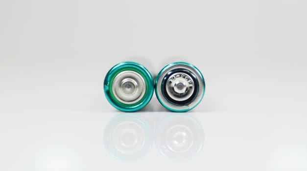 Two alkaline batteries on a white background with reflection. Energy supply and recycling concept. Copy space. Minimalism. Eliment AA is the most common type of galvanic batteries and accumulators