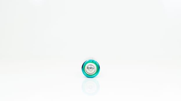 One alkaline battery on a white background with reflection. Energy supply and recycling concept. Copy space. Minimalism. Eliment AA is the most common type of galvanic batteries and accumulators
