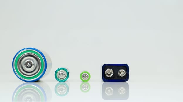 Battery type D or C, PP3, AA, AAA on a white background with reflection. View of metal alkaline batteries with copy space. Mandatory processing