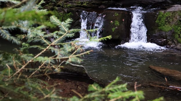 Waterfalls in a small canyon with stone walls. Beautiful cascade in the mountains. river in the Carpathians in the mountain autumn forest. scenic view, the movement of water