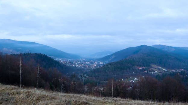 Colorful autumn landscape in a mountain village. Misty morning in the Carpathians. Ukraine, Europe. Beautiful hills and houses. World of beauty. Mountain view in the fall. Beautiful natural landscape