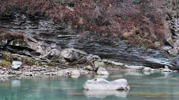 Landscape of a mountain river in the forest in early autumn and late summer. water in a natural stream. beautiful and relaxing forest with a river. River deep in mountain forest. Nature composition