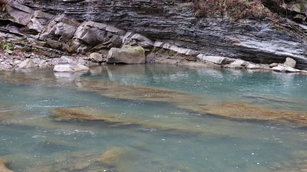 Landscape of a mountain river in the forest in early autumn and late summer. water in a natural stream. beautiful and relaxing forest with a river. River deep in mountain forest. Nature composition