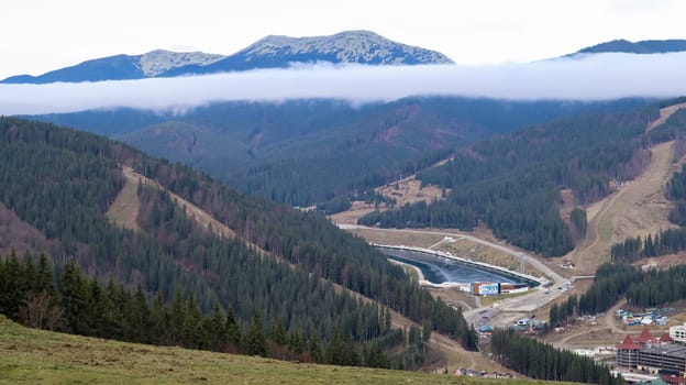Bukovel ski resort in autumn aerial view. View of hotel houses in the ecological countryside against the background of spruce trees and mountain hills.Ukraine, Bukovel - November 20, 2019