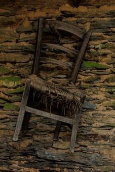 Old chair hanging at the wall
