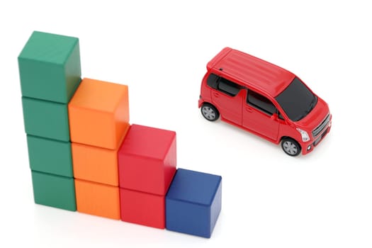 Small toy car and wooden colorful building blocks on white background