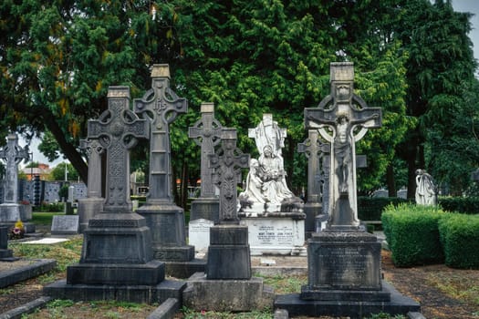 Dublin, Ireland, August 2019 Ancient graves with Celtic crosses and sculptures in Glasnevin Cemetery