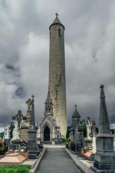 Dublin, Ireland, August 2019 Round Tower and ancient graves and tombstones in Glasnevin Cemetery