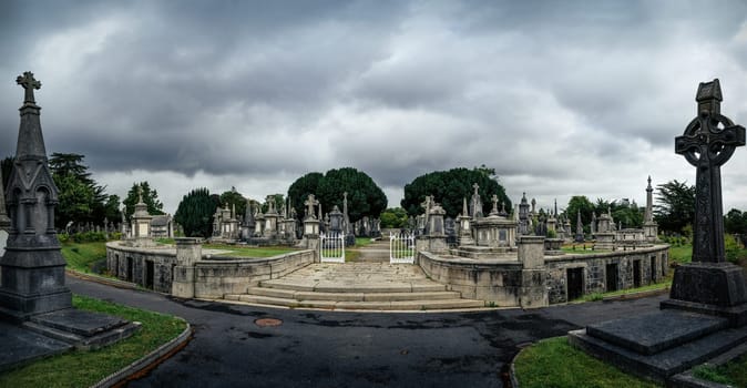 Dublin, Ireland, August 2019 Round mausoleum, cripts, ancient graves and tombstones with Celtic crosses in Glasnevin Cemetery