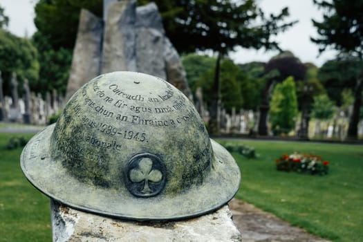 Dublin, Ireland, Aug 2019 Closeup on Irish infantry helmet, a memorial of fallen soldiers who fought in both World Wars, Glasnevin Cemetery