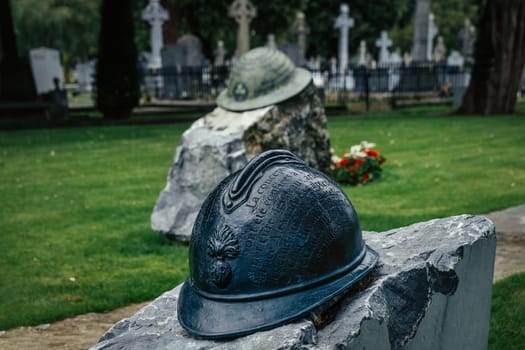 Dublin, Ireland, Aug 2019 Closeup on Irish infantry helmet, a memorial of fallen soldiers who fought in both World Wars, Glasnevin Cemetery