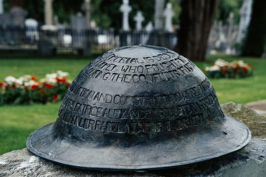 Dublin, Ireland, Aug 2019 Closeup on Irish infantry helmet, a memorial of fallen soldiers who fought in both World Wars, Glasnevin Cemetery
