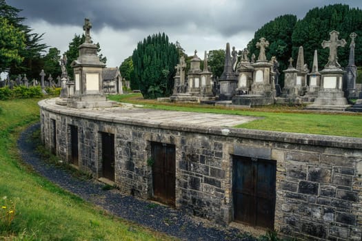 Dublin, Ireland, August 2019 Round mausoleum or crypts with ancient graves and tombstones in Glasnevin Cemetery