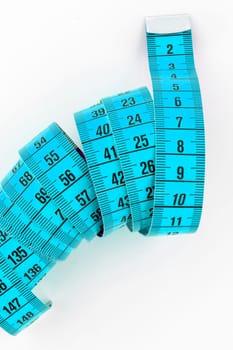 Top view of a blue tailor meter, isolated on white background.