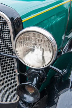 Esens, Germany - September 19, 2021: Reflection of a German classic car in the hubcap of another classic car at the classic car meeting in Esens.