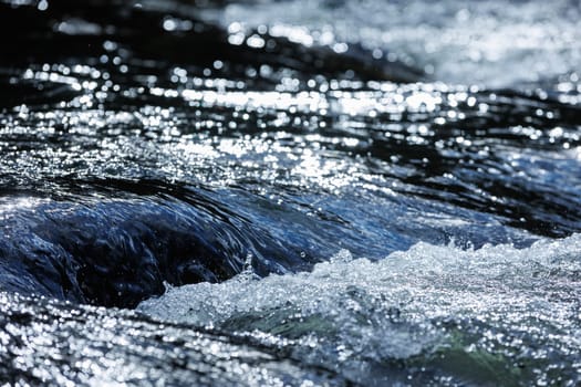Flowing blue fresh water in river