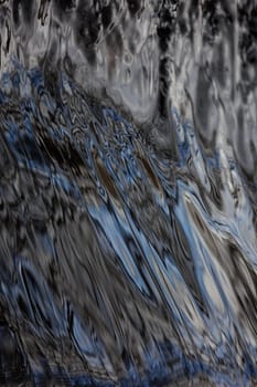 Flowing silver water texture of a river