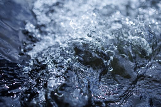 Flowing blue fresh water in river