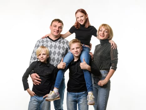 Half-length portrait of an ordinary Russian family in casual clothes on a white background