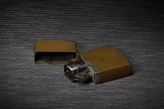 old brass petrol lighter on a dark background close-up, still life
