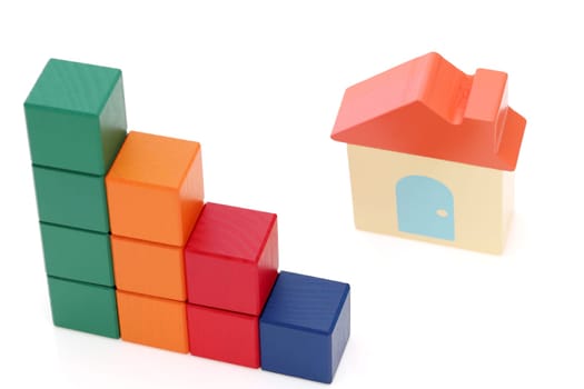 small toy house and wooden colorful building blocks on white background