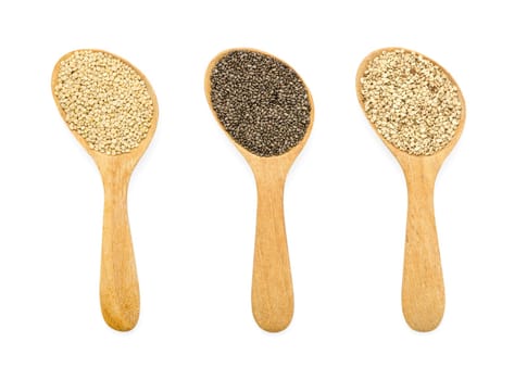 Collection of natural organic superfood of chia seeds, white quinoa and white sesame seeds in wooden spoon on white background