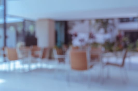 Abstract blur interior coffee shop with empty chairs and tables