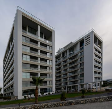 Sleek buildings rise against a moody sky, showcasing modern architectural elements and serene surroundings.