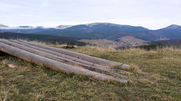 Autumn landscape in the Carpathians with mountain peaks and felled tree trunks. The concept of ecology and illegal deforestation in western Ukraine