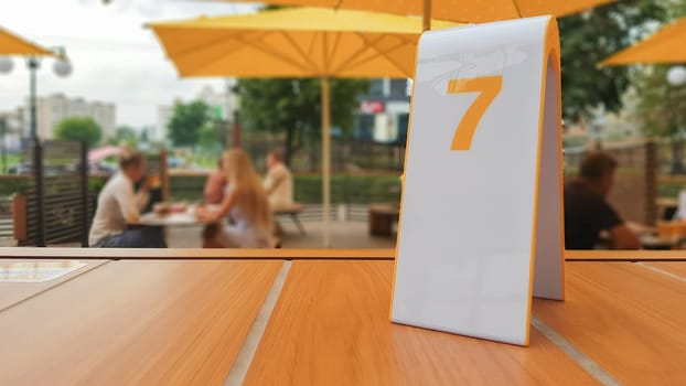 the order number on the table on the street in a McDonald's restaurant. Awaiting an order at a McDonald's restaurant. Fast food with invoice, check. Ukraine, Kiev - September 6, 2019