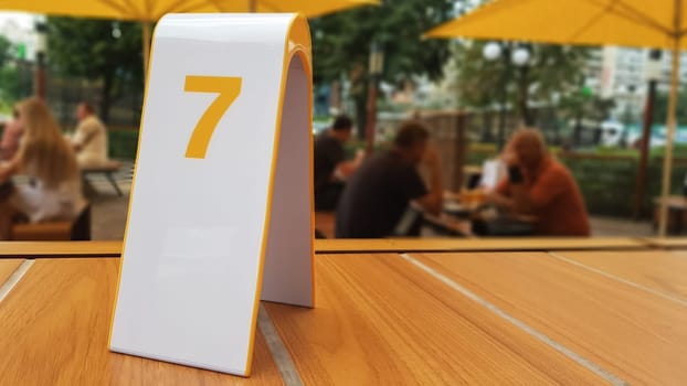 the order number on the table on the street in a McDonald's restaurant. Awaiting an order at a McDonald's restaurant. Fast food with invoice, check. Ukraine, Kiev - September 6, 2019