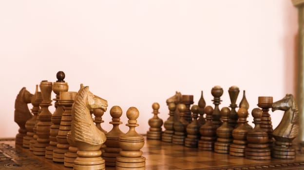 wooden chessboard with wooden brown chess pieces