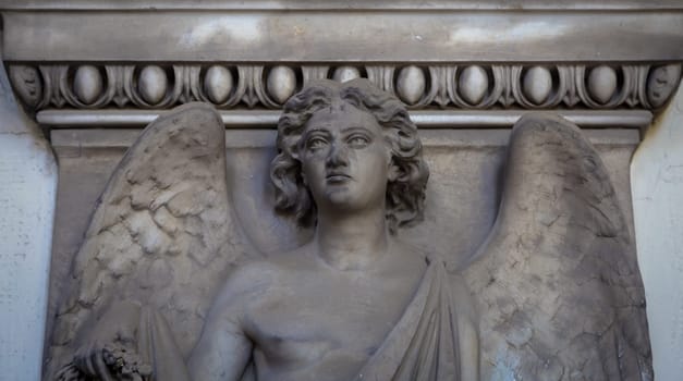 GENOA, ITALY - June 2020: antique statue of angel (beginning 1900, marble) in a Christian Catholic cemetery - Italy
