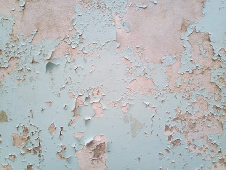 Background texture wall with peeling paint. Peeling old paint off the wall.