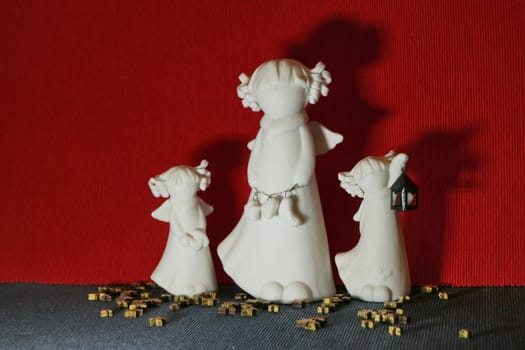 white angels three small figurines in female form angel day concept, still life