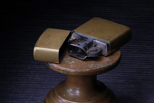 brass petrol lighter on a dark close-up, still life