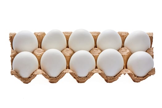 A dozen white eggs on a cardboard stand on a white isolated background. High quality photo