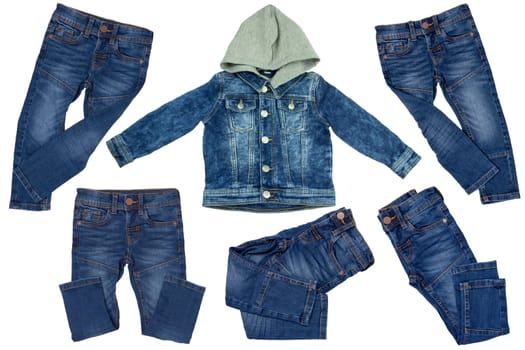Collection jeans clothes on white background. Set of a denim jacket with detachable hood for child boy and various trendy stylish blue denim stretch pants or trousers. Jeans summer and autumn fashion.