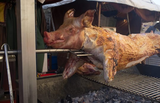 Whole pig being roasted as medieval times. Selective focus