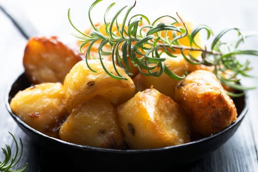 close up of  pan of rustic golden english roasted duck fat potatoes